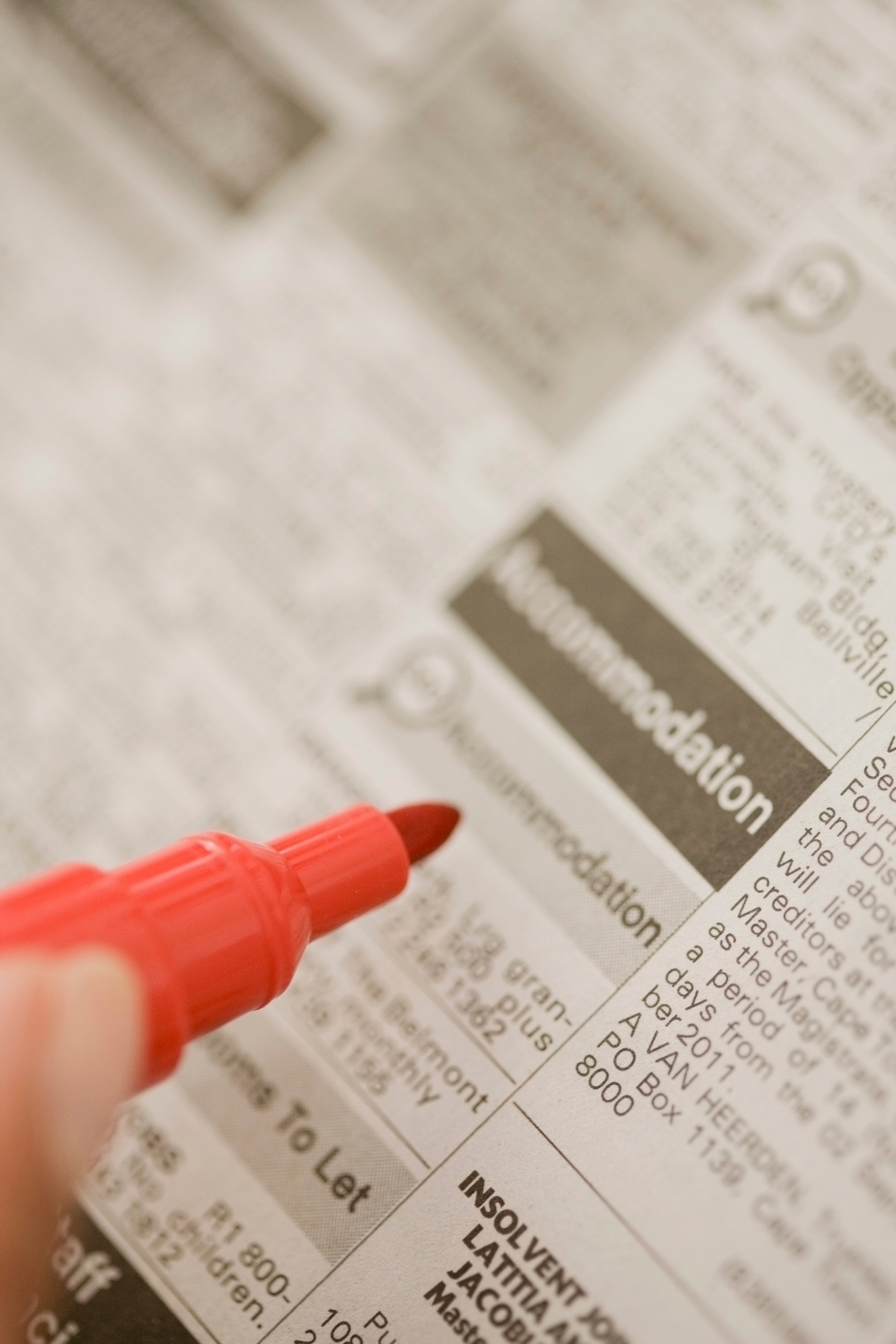 Close up of woman circling ads